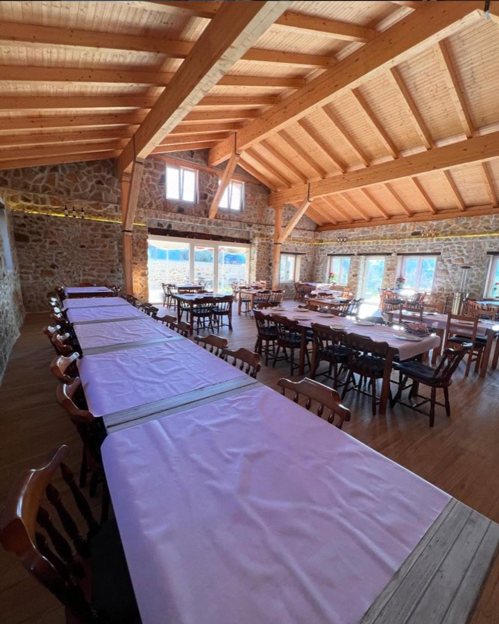 Comedor con vigas de madera y paredes de piedra